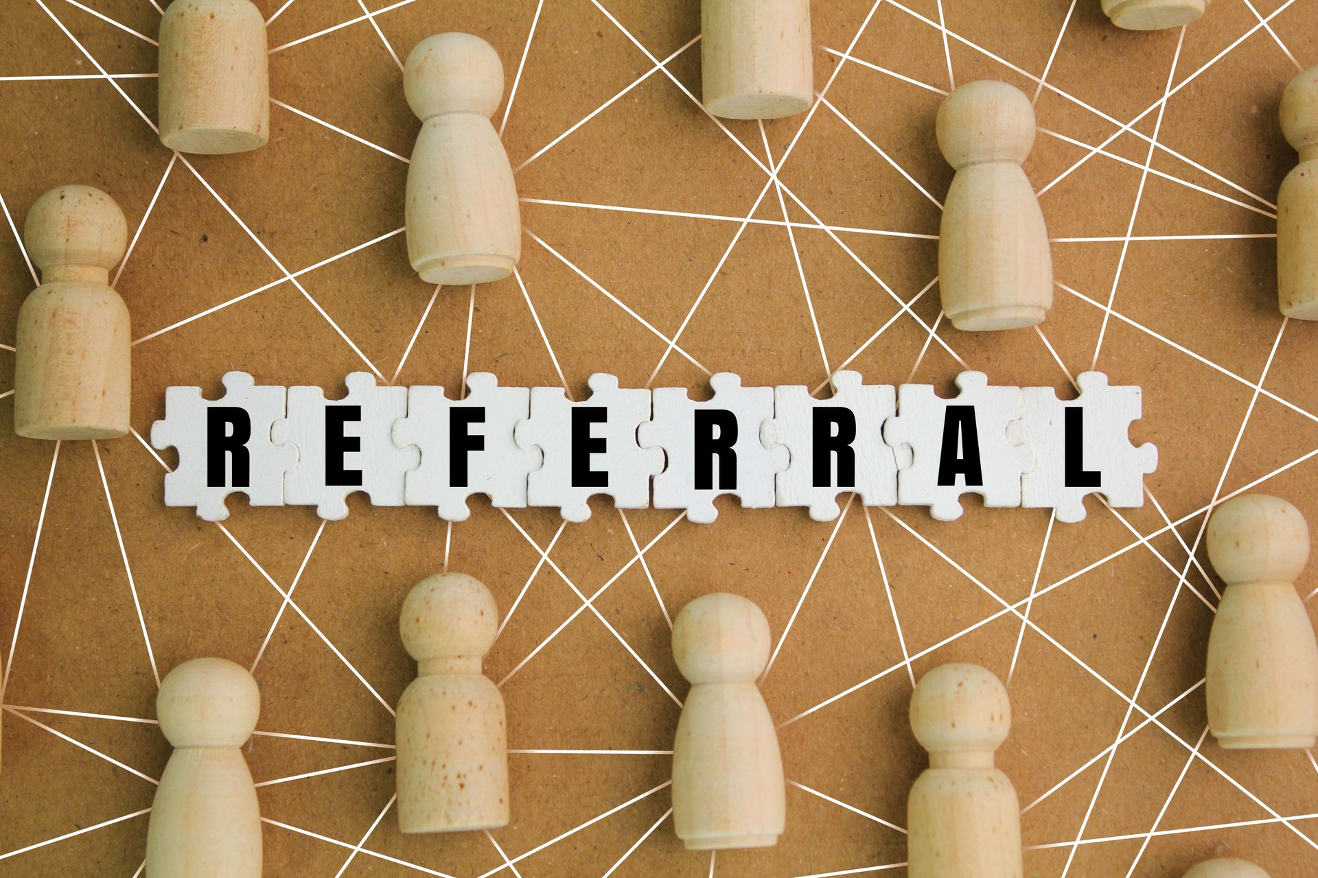 wooden figures with referral alphabet words. reference concept. recruiting strategy in which employers encourage current employees.